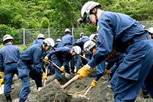 　救助訓練で土砂をかき分ける機動隊員ら＝２４日午後、静岡市