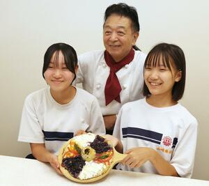 「巴が丘グラタンPIZZA」を紹介する越路中の山崎結羽さん(右)と田中彩羽さん、丘の上の迎賓館の岩崎淳鋭さん=長岡市朝日