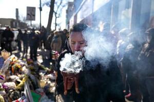 27日、米ミネソタ州ミネアポリスで、連邦捜査官に射殺された男性の死を悼む人々(ゲッティ=共同)