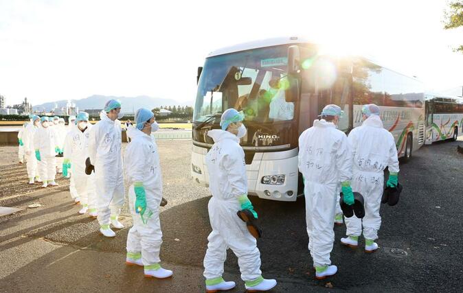 作業のため、現場へ向かうバスに乗り込む県職員＝４日、胎内市