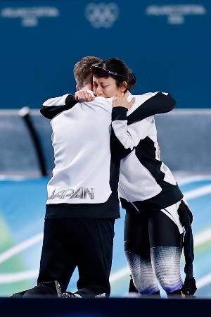　女子１５００メートルで６位となり、ヨハン・デビット・コーチ（手前）と抱き合う高木美帆＝ミラノ（共同）