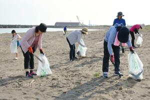 浜辺のごみを拾い集める上越信用金庫の職員ら=上越市