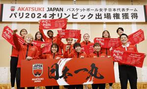 バスケットボール女子のパリ五輪世界最終予選で3大会連続の五輪出場を決め帰国し、ポーズをとる日本チーム=2月13日、千葉県成田市