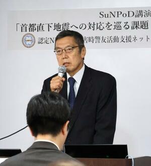 講演会であいさつするNPO法人「災害時警友活動支援ネットワーク」の竹内直人さん=23日午後、東京都港区