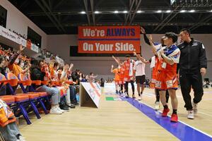 試合終了後、ブースターとともにプレーオフ進出を喜び合う新潟の選手ら=アオーレ長岡
