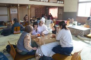 こたつを囲んで談笑する来場者=津南町下船渡