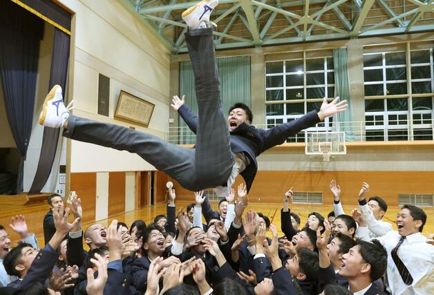 ソフトバンクから育成１位で指名された関根学園の池田栞太捕手。胴上げされる＝関根学園高校