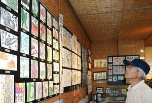 野菜や花がはがきいっぱいに描かれた作品が並ぶ「ほのぼの絵手紙久美子と仲間たち展」=新潟市江南区木津2