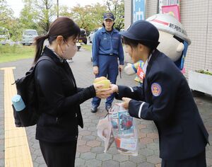 地元特産のナシを配って火災予防を呼びかける江南消防署員ら=新潟市江南区泉町3