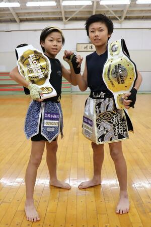 勝者に贈られるチャンピオンベルトを手にする兄の髙橋琥珀さん(右)と弟の碧さん=新潟市東区
