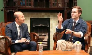 　長崎市の鈴木史朗市長（左）と対談するクレイグ・モドさん＝１９日午後、長崎市