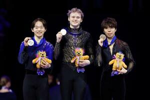 男子の表彰式でメダルを掲げる(左から)2位の鍵山優真、優勝のイリア・マリニン、3位の佐藤駿=プラハ(共同)