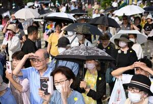 梅雨明けしたとみられる名古屋市で、日傘を差して街頭演説を聞く人たち=4日午後