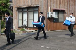 容疑者の自宅に家宅捜索に入る福島県警の捜索関係者＝２０日午前８時前、胎内市