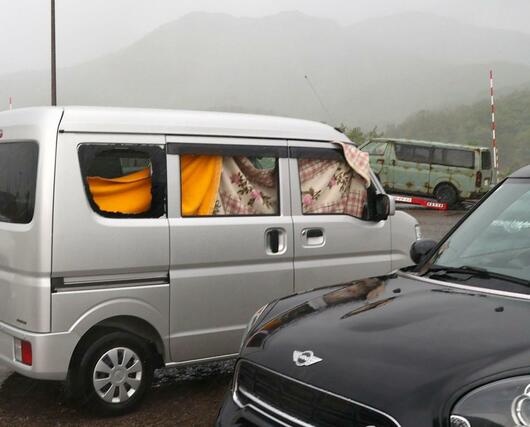 ２０台以上の車の窓ガラスが割れた新井ＰＡ。強風などによる被害とみられ、毛布などで応急措置する車もあった＝４日、妙高市猪野山
