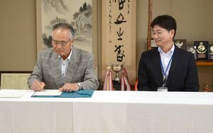 合意書を取り交わす水沢地区インター推進協議会の川田一幸会長(左)と、長岡国道事務所の田村秀誠所長=十日町市伊達甲