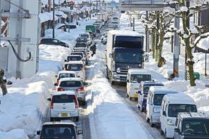 雪で道が狭くなり渋滞が発生した幹線道路=12月21日、長岡市
