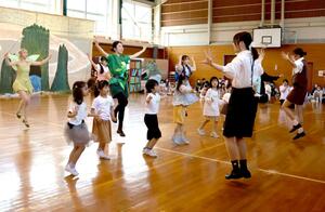 ミュージカル本番に向け、振り付けなどを確認する新潟中央短大の学生や地域の子どもたち＝田上町川船河