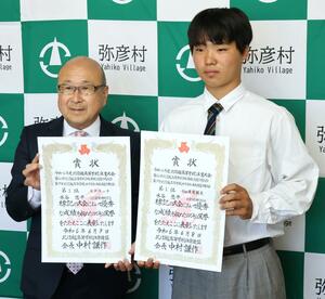 本間芳之・弥彦村長(左)に、北信越高校体育大会の自転車トラック種目での2冠を報告した水谷悠平さん=弥彦村役場
