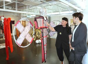 滞在中に生まれた作品を見ながら交流する作家と来場者＝２３日、新潟市中央区二葉町２