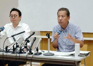 第1回口頭弁論を終え、支援者らに報告する兵庫県の丸尾牧県議(右)=27日午後、兵庫県尼崎市