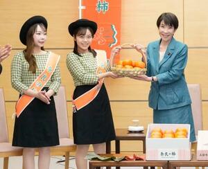 奈良県特産の柿を贈呈される高市首相(右)=19日、首相官邸