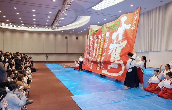 大きな筆を使ったパフォーマンスを披露する東京学館新潟高校の書道部員＝４日、新潟市中央区