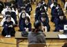友田典弘さん(手前)の被爆証言に耳を傾ける広島市立袋町小学校の児童ら=2025年11月