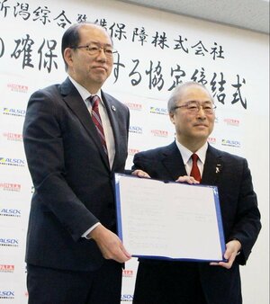 協定を結んだ県信用組合の赤川新一理事長（左）と新潟綜合警備保障の廣田幹人社長＝９日、新潟市中央区