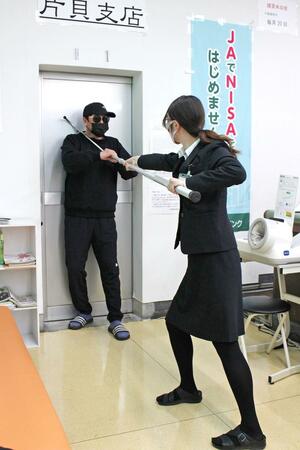 JA魚沼片貝支店で行われた強盗訓練。さすまたの使い方を学んだ=小千谷市片貝町