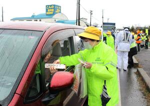 乾麺を配り事故防止を呼びかける江南地区交通安全協会の会員ら=1日、新潟市江南区
