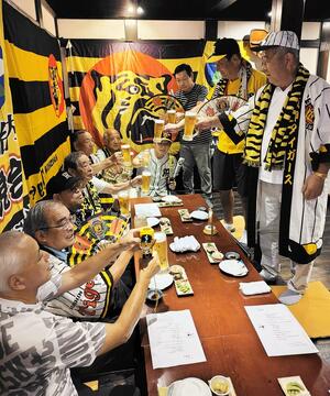 リーグ優勝の「前祝い」とばかりに乾杯する新潟胎内猛虎会のメンバー=胎内市東本町