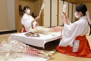 縁起物の準備をする弥彦神社の巫女=12月2日、弥彦村弥彦