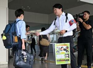 吉川友梨さんが行方不明になった事件で、情報提供を呼びかける大阪府警の捜査員=2日午前、JR熊取駅