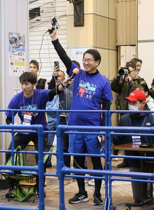 イベントで号砲を鳴らす中原八一新潟市長。今年に入り地域行事に細かく顔を出している=新潟市中央区