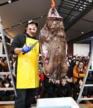 多くの見物客の前で実演されたアンコウのつるし切り=糸魚川市の糸魚川駅