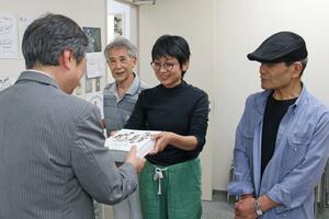 英語版「阿賀のお地蔵さん」を贈った岡部安曇さんら=5月18日、新潟市北区前新田の県立環境と人間のふれあい館