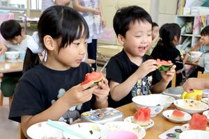給食で小玉スイカのNiigataルビームーンを味わう子どもたち=新潟市西区山田
