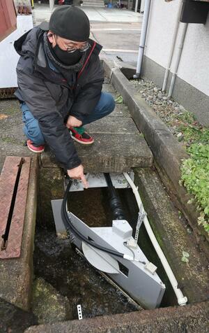 流雪溝の水流を自動で分岐できる雲田商会の制御システムの装置=妙高市田町2