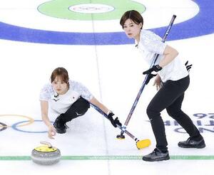 　ミラノ・コルティナ冬季五輪のイタリア戦でショットを放つカーリング女子日本代表で最年少の小林未奈（左）＝１７日、イタリア・コルティナダンペッツォ（共同）