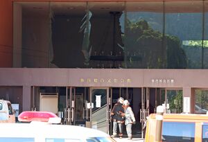 改修工事現場で爆発事故があった、弥彦総合文化会館。爆風の影響か、玄関のガラスが割れていた=6月29日、弥彦村弥彦