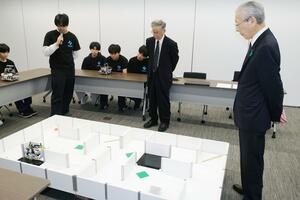 「ロボカップジュニア・ジャパンオープン」のレスキュー部門で優勝し、新発田市役所で実演する猿橋中の源田悠人さん（左）