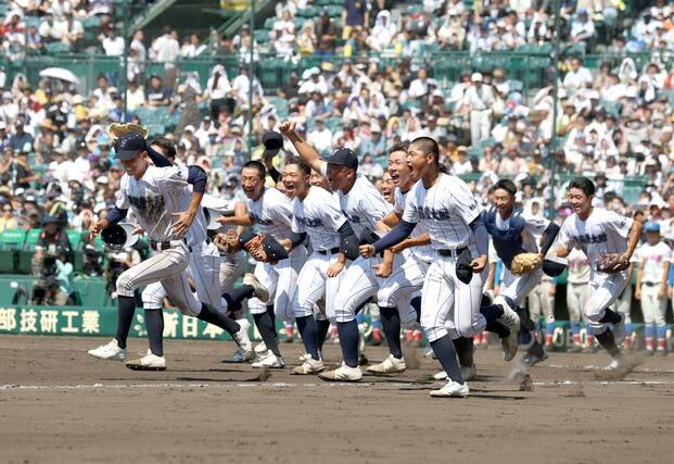 校歌を歌い終え、応援席へ笑顔で走り出す選手たち＝甲子園