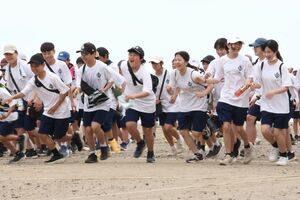 がんばり行軍で一斉にスタートする生徒たち＝上越市の郷津海岸