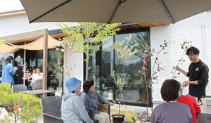 「植×食フェス」で庭木の説明を受ける来場者ら=4月27日、三条市柳場新田