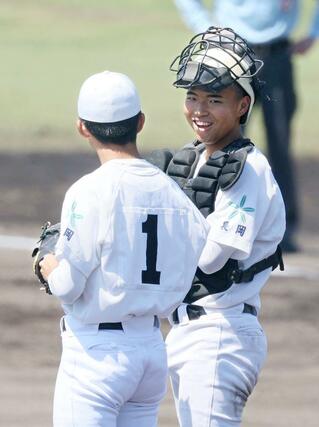 糸魚川－長岡大手　１回糸魚川２死一塁、長岡大手先発の蒲生敦大（左）に笑顔で声をかける捕手齊田海斗＝２日、柏崎市佐藤池球場