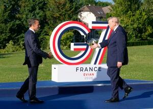 G7サミットの歓迎式典でトランプ米大統領(右)を迎えるフランスのマクロン大統領=15日、フランス東部エビアン(共同)