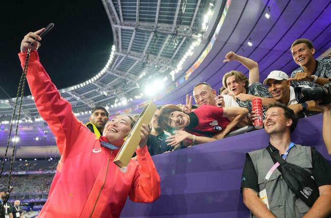 女子やり投げで金メダルを獲得し、観客席を背に自撮りする北口榛花＝パリ郊外（共同）