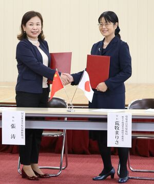 佐渡市で生まれたトキの中国返還について署名を交わした日中両国の担当者=10月29日、佐渡市