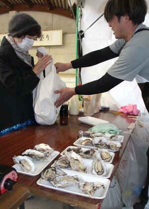 蒸しガキなどを求めて行列ができた「佐渡牡蠣祭り」=3月16日、佐渡市両津湊